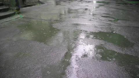 Raindrops in a puddle. Puddles in the city. Puddle on the asphalt. Stock Footage 198199462