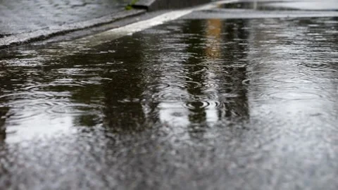 Raindrops on puddle. Rainy day. Super Slow motion 4K Stock Footage 305989229