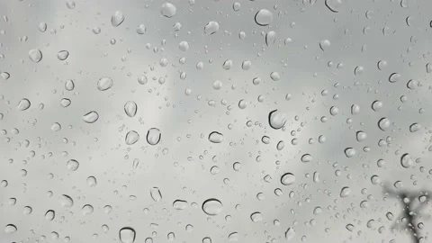 Raindrops, raindrops falling on the car window on a rainy day in Brazil, 4k.. Video stock 240011868