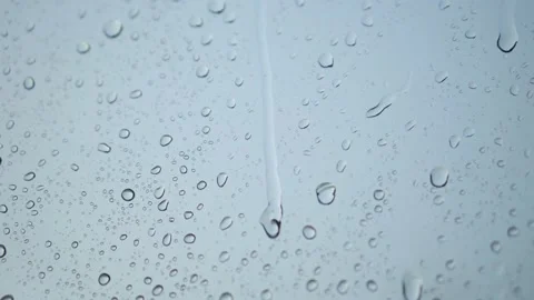 Raindrops roll down on the window. Bad depressive weather, heavy rain and wind Stock Footage 156440424