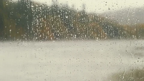 Raindrops rolling down window bleak stormy weather Stock Footage 115059418