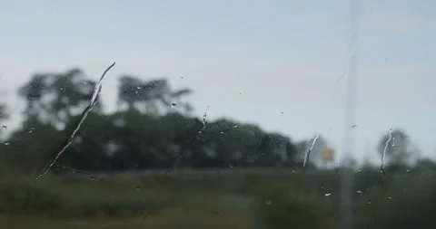 Raindrops run down the glass of a commuter bus in cloudy and rainy weather. Stock Footage 304194842