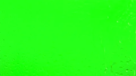 Raindrops run down the glass on a green background. Rainy weather. Stock Footage 174913870