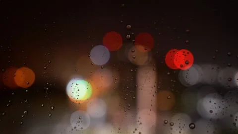 Raindrops run down the glass at night. Raindrops on the glass on the backgrou Stock Footage 134382513