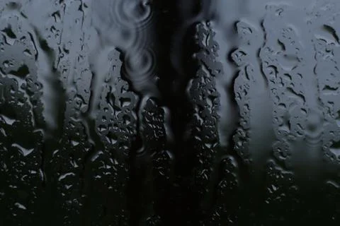 Raindrops run down the glass Stock Photos