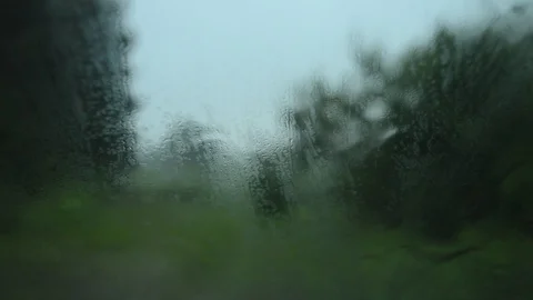 Raindrops run down the misted glass of the car Stock Footage 98180677
