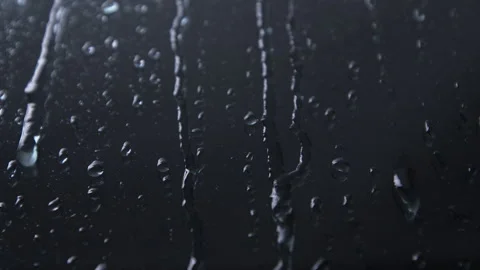 Raindrops run down the window glass in the dark. Water drops, close-up. Rain. Stock Footage 145761237
