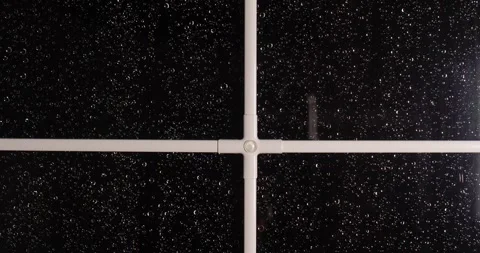 Raindrops run down the window glass. Night Stock Footage 258328793