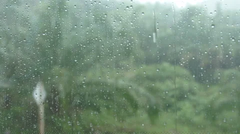 Raindrops running down a window Stock Footage 68738774