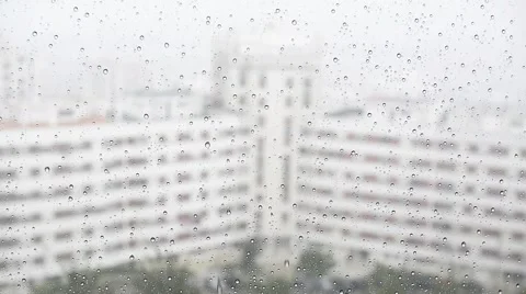 Raindrops running down a window glass in the rain Stock Footage 68902983