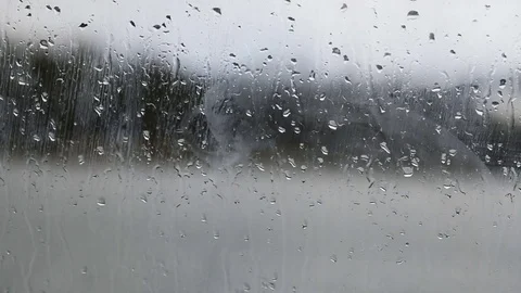 Raindrops running down on a window glass Video stock 83522796