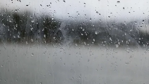 Raindrops running down on a window glass Video stock 83522801