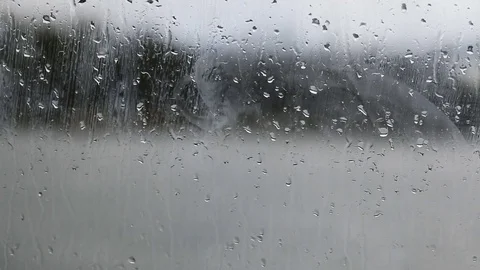 Raindrops running down on a window glass Video stock 83522835