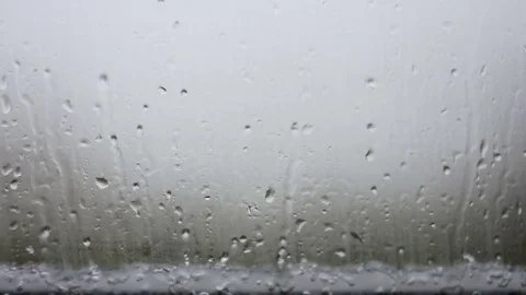 Raindrops running down on a window glass Video stock 83522893