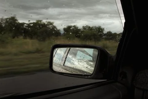 Raindrops on side mirror of car Stock Photos