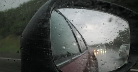 Raindrops on side view mirror Stock Footage 265240175
