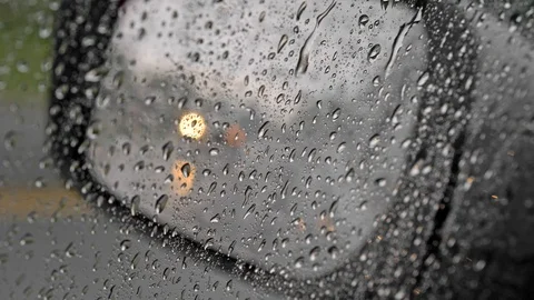 Raindrops on a side window of a car. Blurred lights of passing by cars 스톡 동영상 114063833