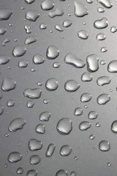 Raindrops on silver surface Stock Photos