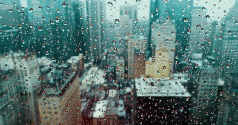 Raindrops on Skyscraper Window Overlooking Modern Cityscape Stock Footage 323147407