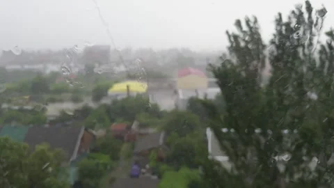 Raindrops slide down the window glass, showcasing the natural process of mo.. Video stock 312253123