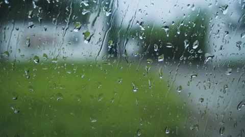Raindrops Sliding Down A Car Window During A Summer Storm Over Green Landscape 動画素材 341997351