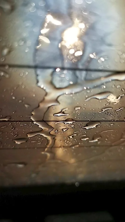Raindrops sliding down a car window with defroster lines. Stock Footage 345530452