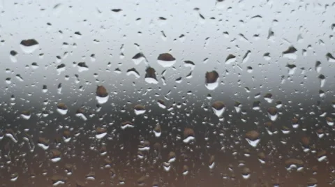 Raindrops sliding down a glass window pane Stock Footage 65873158
