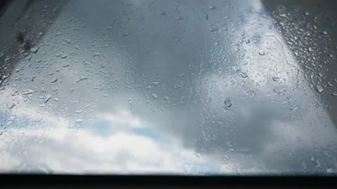 Raindrops Sliding Down Window Glass in Skylight Close-Up Stock Footage 345426243