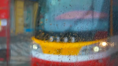 Raindrops sliding on tram window during rainy day Stock Footage 317171660