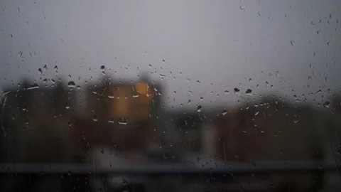 Raindrops sliding on a window and a lightning on the sky Stock Footage 139058646