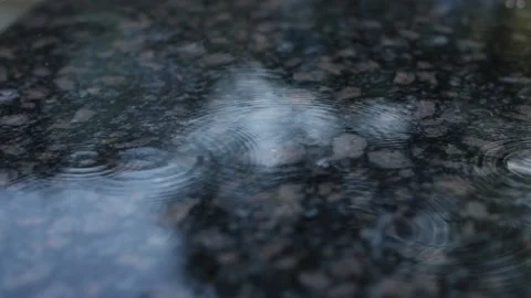 Raindrops in slow motion fall on a granite surface. Stock-Footage 179525274