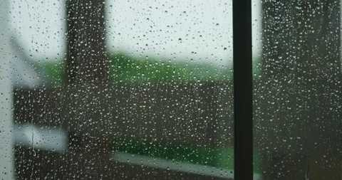 Raindrops slowly rolling down window as heavy storm winds blow outside in Stock Footage 196925504