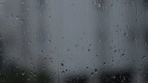 Raindrops slowly running down the window glass, gray background Stock Footage 229882323