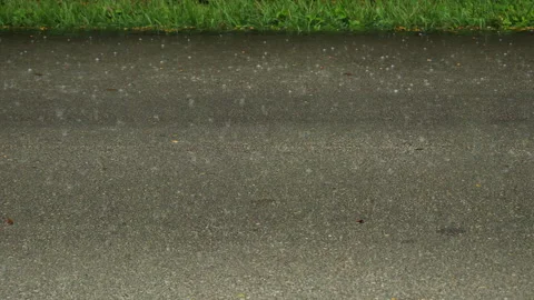Raindrops Spatter on Pavement Green Grass Stock Footage 284776074