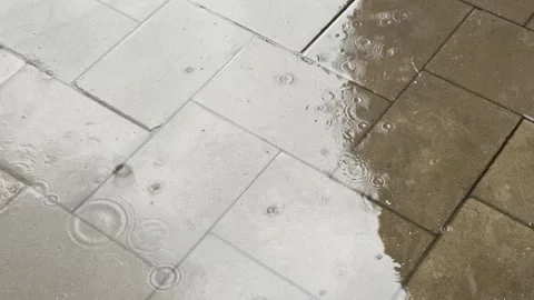 Raindrops splashes onto the pavement. Rainy day in the city. Rain drop ripp.. Stock Footage 313302870