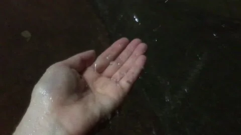 Raindrops splashing on my hand. Video stock 137436086
