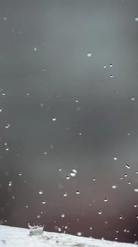 Raindrops splashing on pale ground in vertical format Foto stock