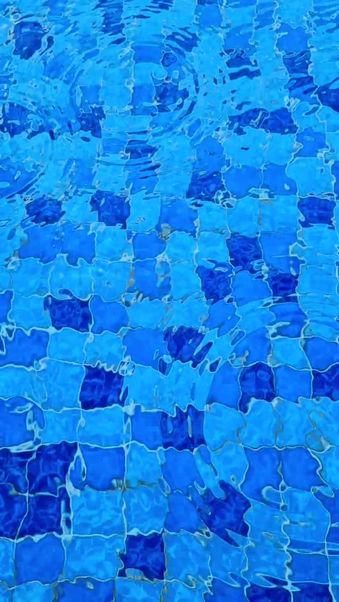 Raindrops splashing of swimming pool surface, close up. Stock Footage 254487461