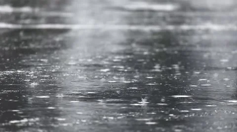 Raindrops Splatter on the Pavement Stock Footage 62493410
