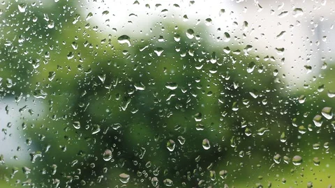 Raindrops stick down a glass window in rainy weather Stock Footage 128296653