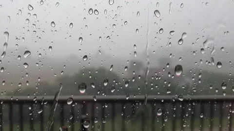 Raindrops sticking to the window during heavy rain Stock Footage 138496357