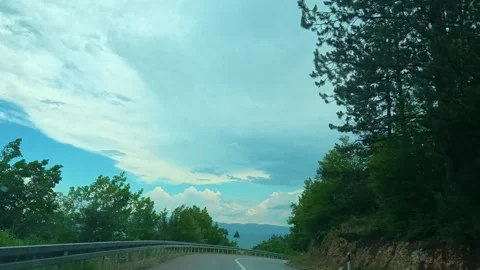 Raindrops streak across a car window. Balkan Mountains, Serbia 스톡 동영상 341876950