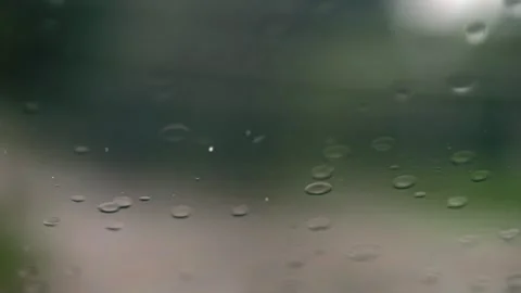 Raindrops streak down the glass in slow motion, with wipers battling the pe.. Stock Footage 256645279