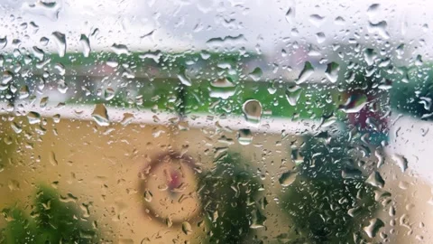 Raindrops stream down the glass surface on a stormy day. Stock Footage 338241452