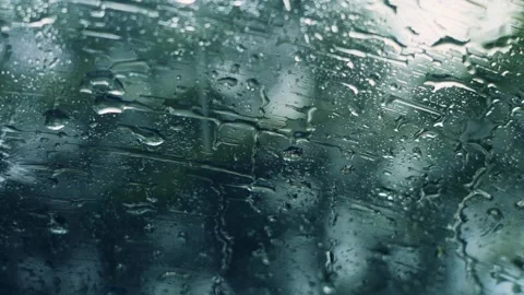Raindrops Streaming Down Glass Surface on a Melancholy Rainy Day Stock Footage 341913395