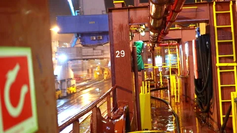 Raindrops strike deck forming trembling ripples in puddles Stock Footage 320434822