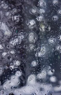 Raindrops on a surface glass with a close-up top-down perspective, creating.. Stock Photos