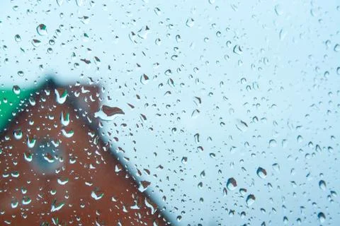 Raindrops texture with house on background. Stock Photos