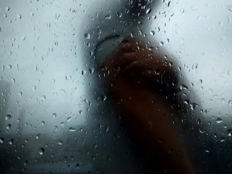 Raindrops on a textured window Stock Photos