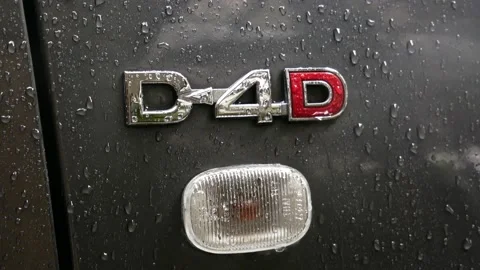 Raindrops on Toyota D-4D engine badge designation on grey SUV Stock Footage 150165531